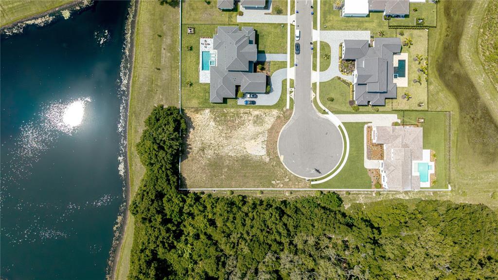 An aerial view shows a vacant residential lot situated in a cul-de-sac near a lake — 2504 WINDERMERE RESERVE COURT, WINDERMERE, FL