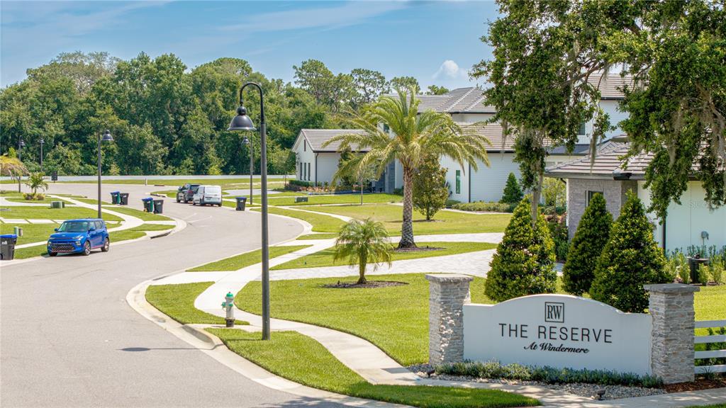 A street view of the entrance sign for The Reserve at Windermere with nearby houses — 2504 WINDERMERE RESERVE COURT, WINDERMERE, FL
