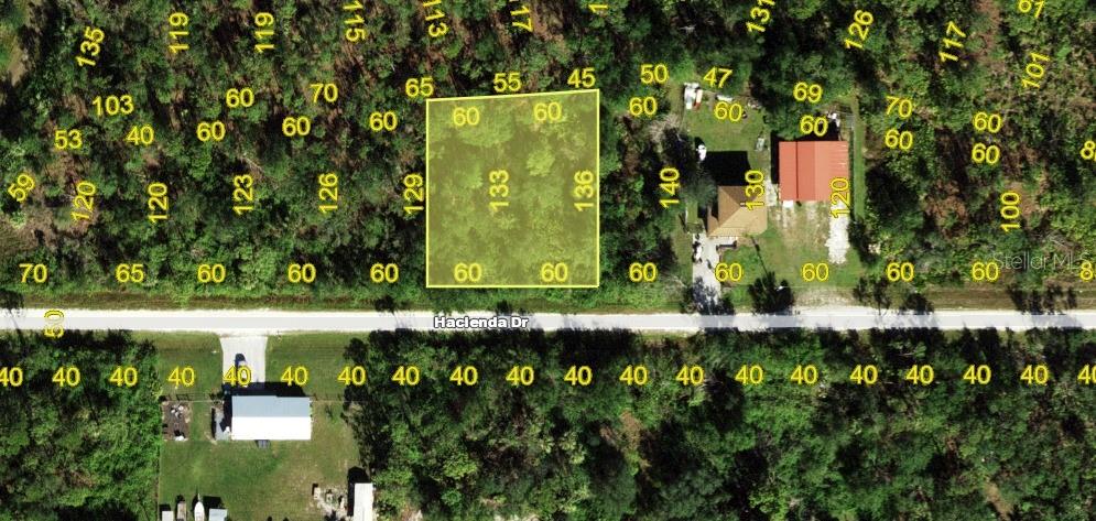 This aerial map shows a vacant rectangular lot highlighted in yellow along Hacienda Drive — 27198 & 27204 HACIENDA DRIVE, PUNTA GORDA, FL
