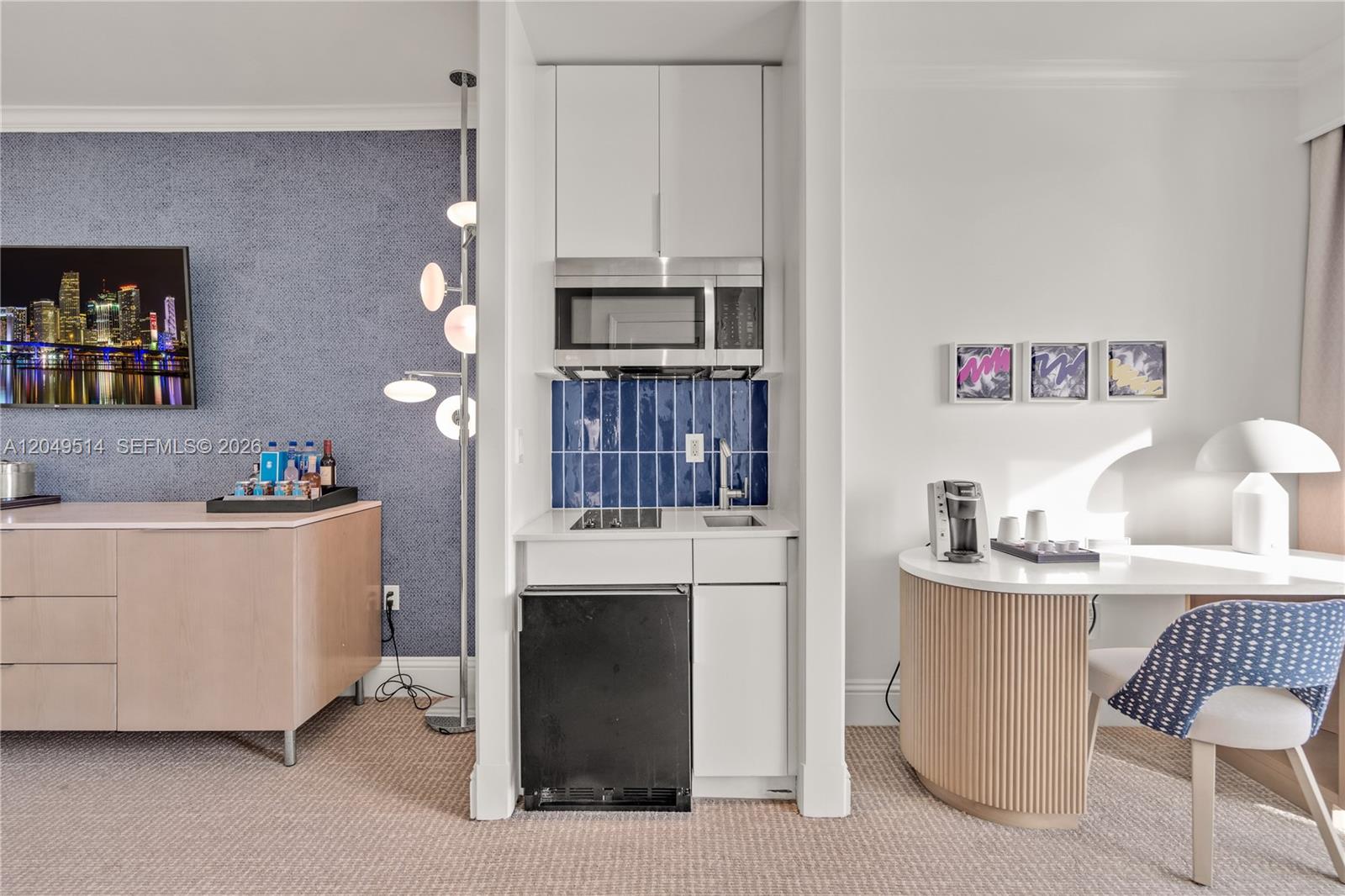 A hotel room features a kitchenette with a microwave, mini-fridge, and blue tiled backsplash — 4401 Collins Ave # 1508, Miami Beach FL 33140, MIAMI BEACH, FL