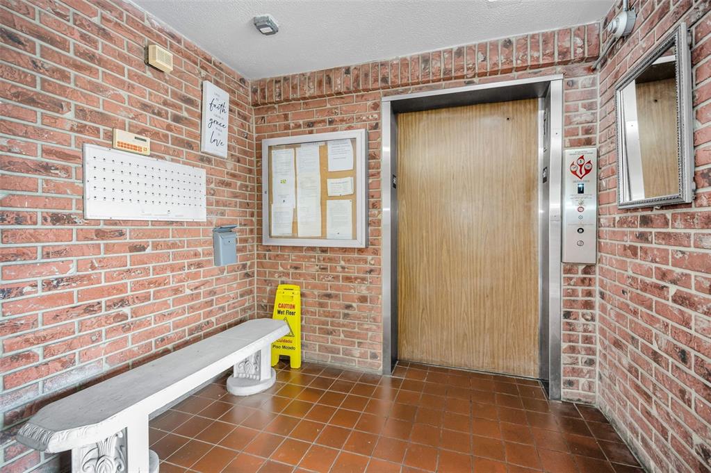 A covered entryway with a tiled floor leads to a building labeled Dartmouth — 5501 80TH STREET N UNIT 405, ST PETERSBURG, FL
