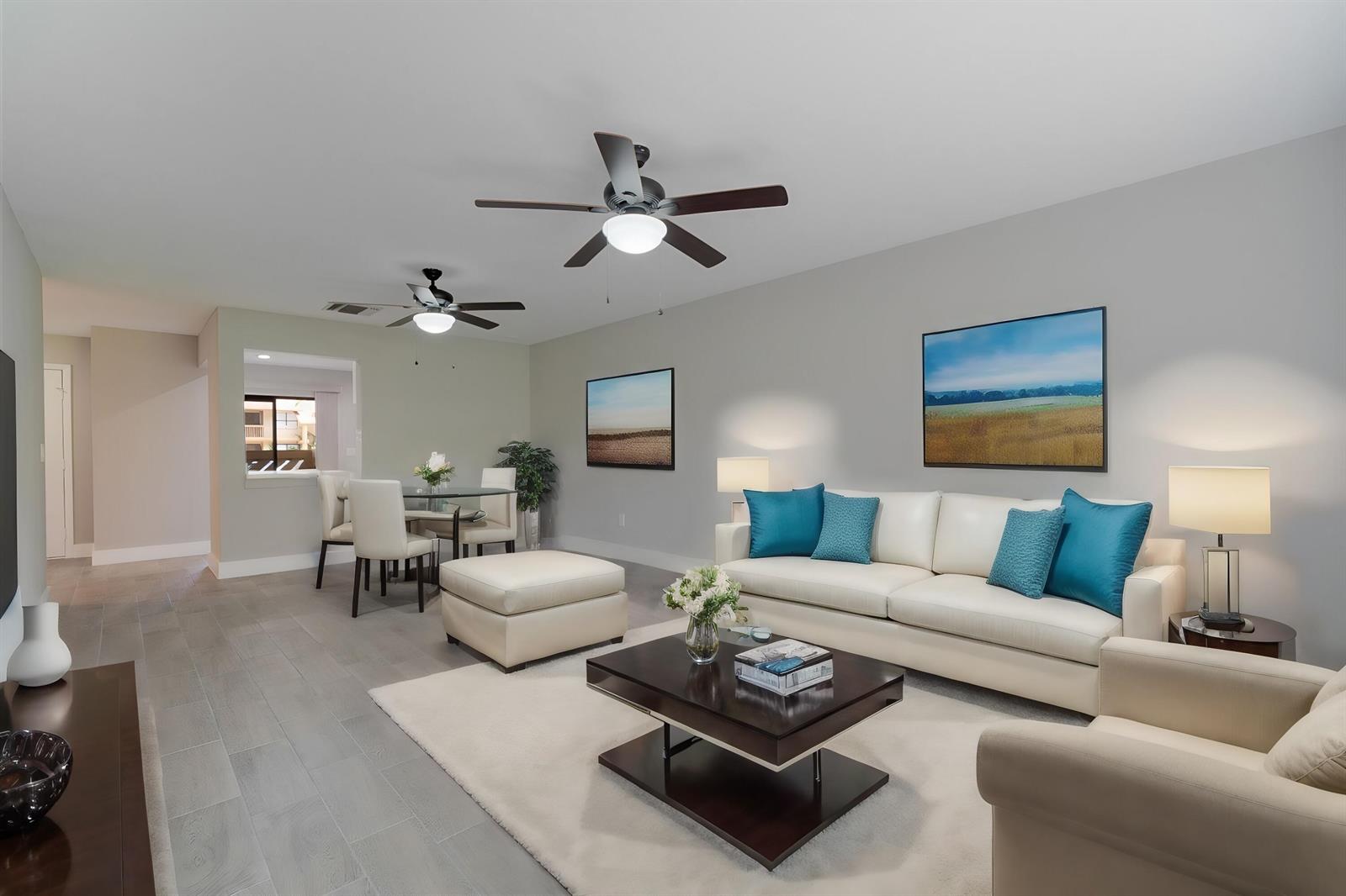 A living room features a white sofa, a dark coffee table, and a dining area — WELLINGTON, FL
