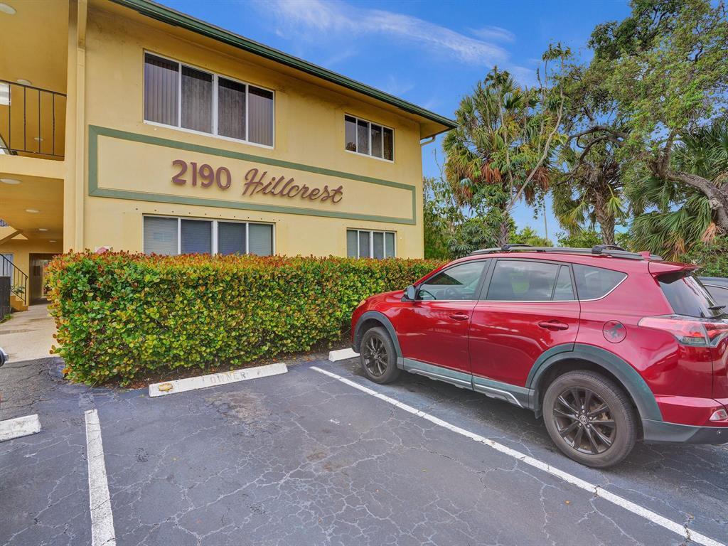 A red SUV is parked in front of a yellow two-story apartment building — 2190 SE 5th Street # a, Pompano Beach FL 33062, POMPANO BEACH, FL