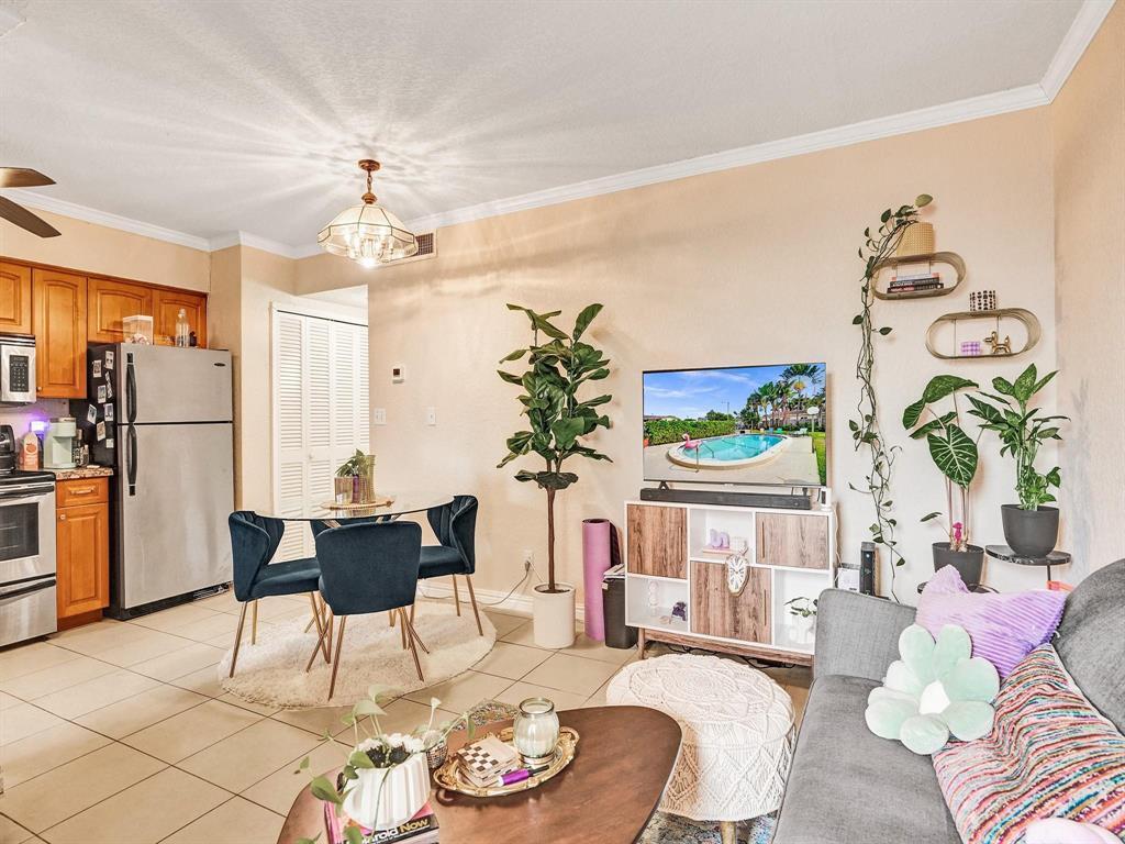 A living room and kitchen area featuring tile flooring, a dining table, and houseplants — 2190 SE 5th Street # a, Pompano Beach FL 33062, POMPANO BEACH, FL