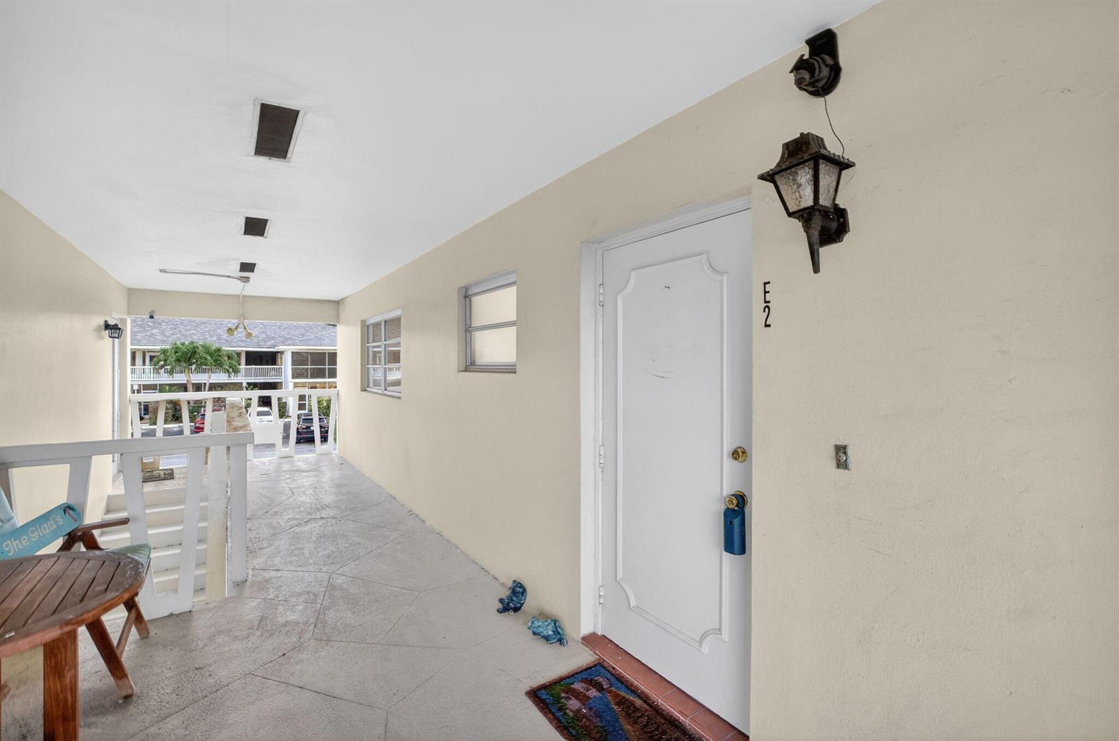An exterior walkway leads to a white front door marked with the number E2 — 2755 NE 28th Avenue # E2, Lighthouse Point FL 33064, LIGHTHOUSE POINT, FL