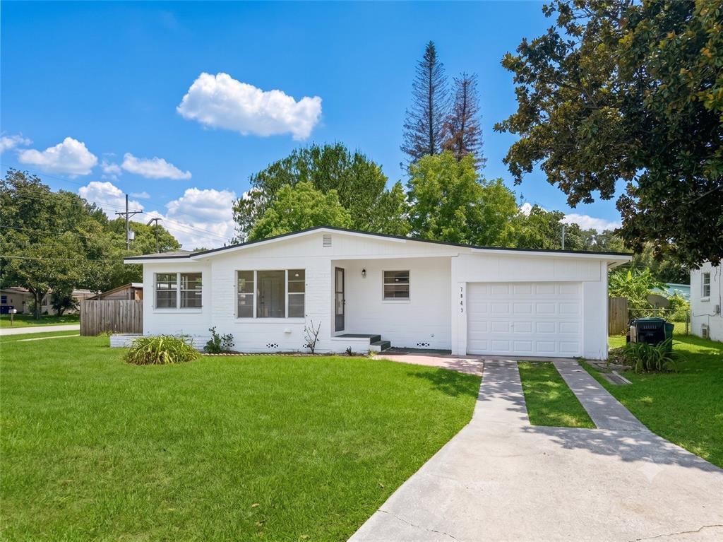 A white single-story house with a front-facing garage and a concrete driveway — 3502 ARCH STREET, ORLANDO, FL