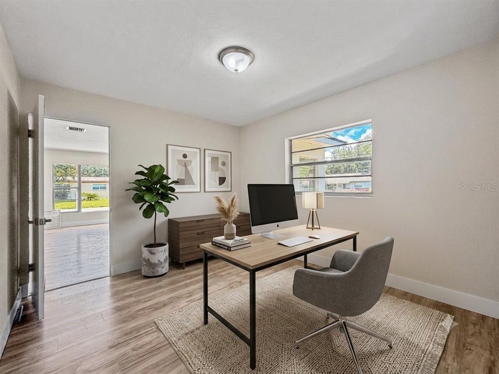 A bathroom features a white vanity, a toilet, a rectangular mirror, and tiled flooring — 3502 ARCH STREET, ORLANDO, FL