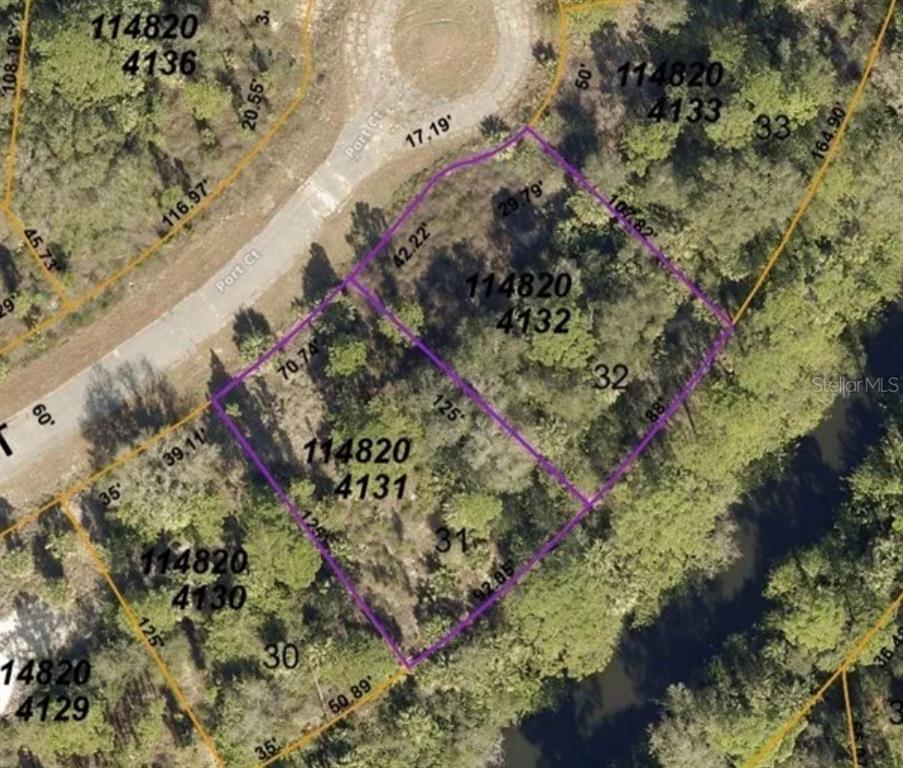 This is a satellite map showing two adjacent residential lots outlined in purple — PORT COURT, NORTH PORT, FL