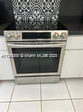 A stainless steel electric range is installed in a kitchen with patterned backsplash tiles — 6450 Collins Ave # 206, Miami Beach FL 33141, MIAMI BEACH, FL