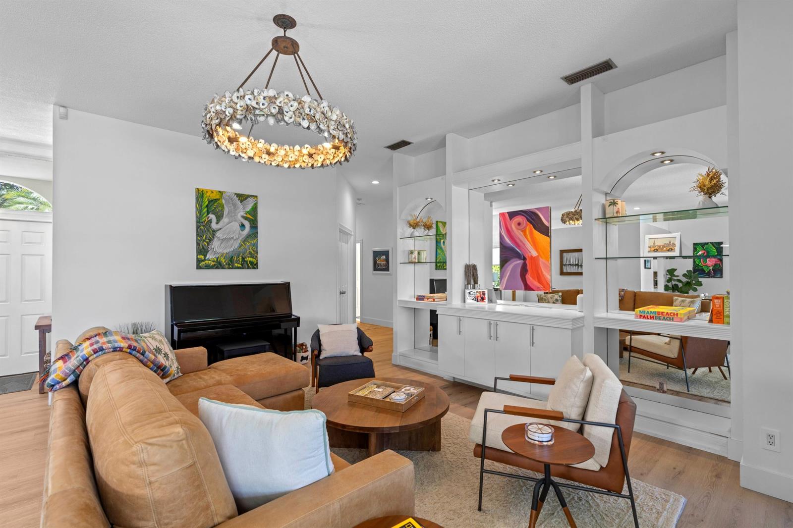 A living room features a tan sectional sofa, a round coffee table, and built-in shelving — 1205 Gator Trail, West Palm Beach FL 33409, WEST PALM BEACH, FL