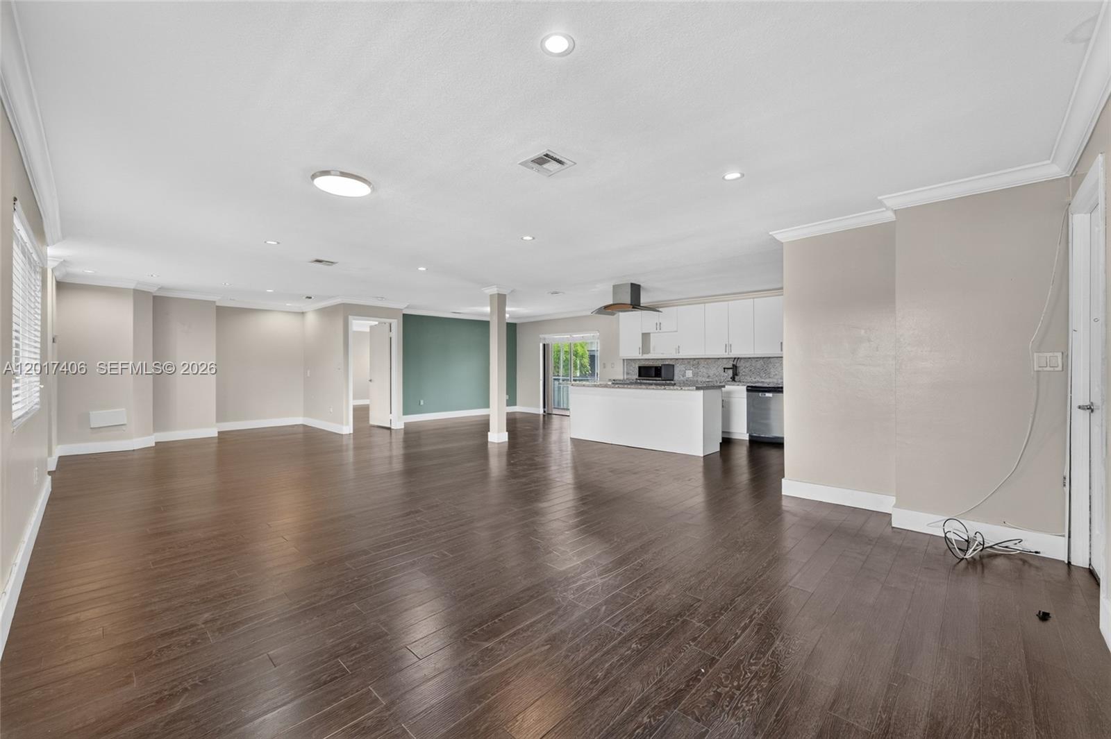 This open-concept living area features dark wood flooring, recessed lighting, and a modern kitchen — 8401 SW 107th Ave # 316E, Miami FL 33173, MIAMI, FL