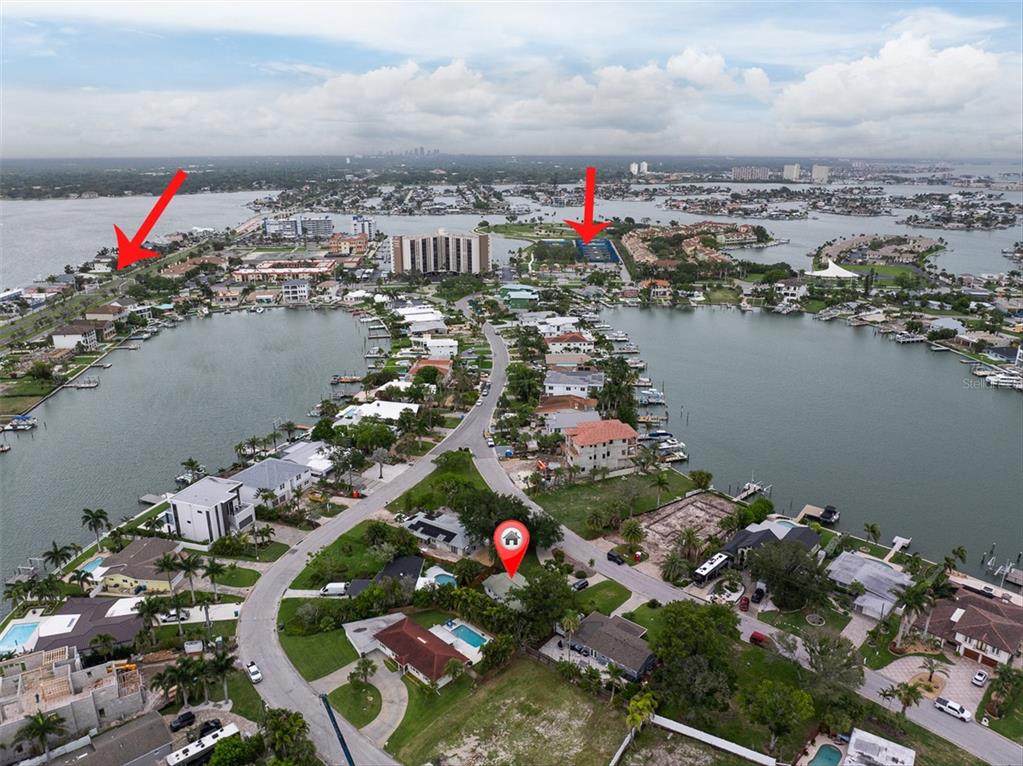 An aerial view shows a residential neighborhood on a peninsula surrounded by water — 55A DOLPHIN DRIVE, TREASURE ISLAND, FL