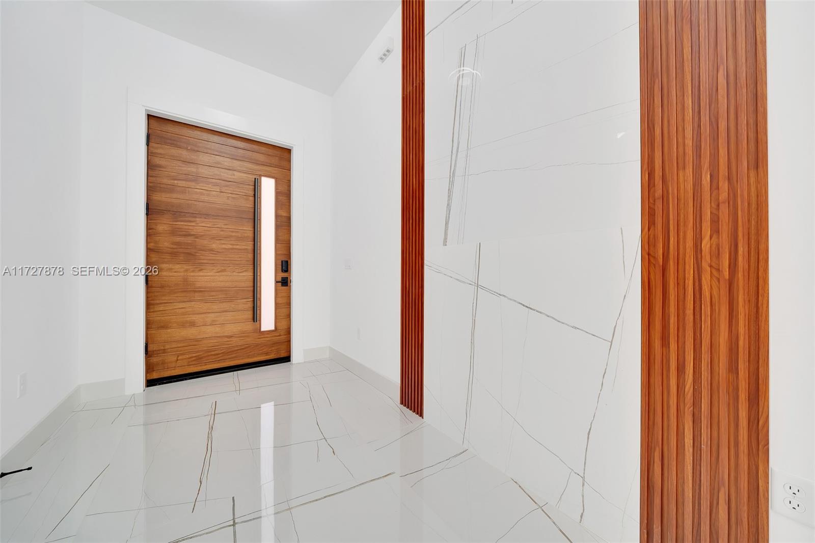 FOYER WITH WATERFALL OF TILE TRIMMED WITH MAHOGANY ACOUSTIC PANELS — OCALA, FL