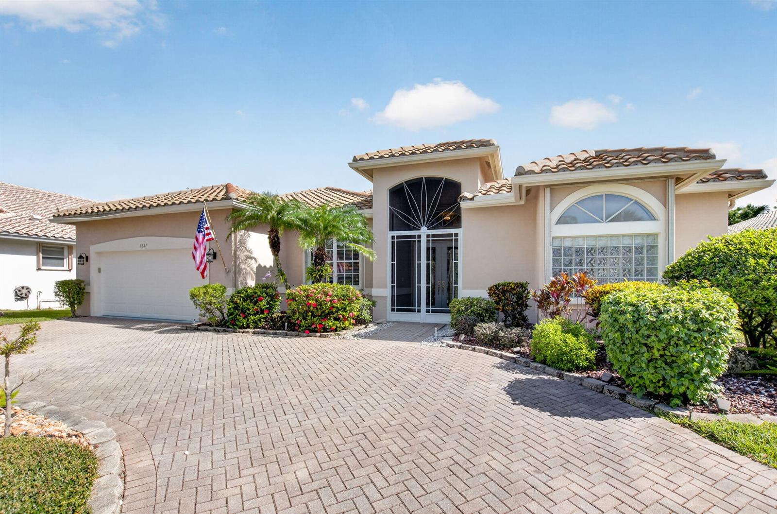 A single-story house with a paved driveway, tile roof, and a glass block window — 5281 Brooklawn Terrace, Boynton Beach FL 33437, BOYNTON BEACH, FL