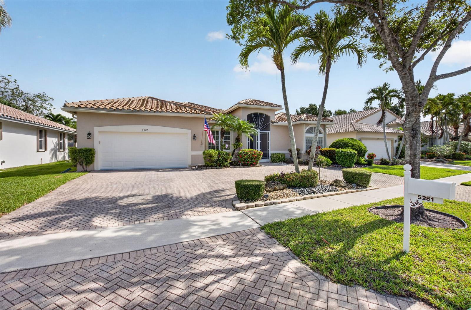 A single-story house with a tiled roof, a brick driveway, and palm trees in front — 5281 Brooklawn Terrace, Boynton Beach FL 33437, BOYNTON BEACH, FL