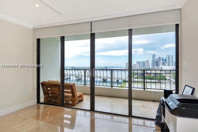 A room with tile floors features a large sliding glass door opening to a balcony — 555 NE 15th St # 16H, Miami FL 33132, MIAMI, FL