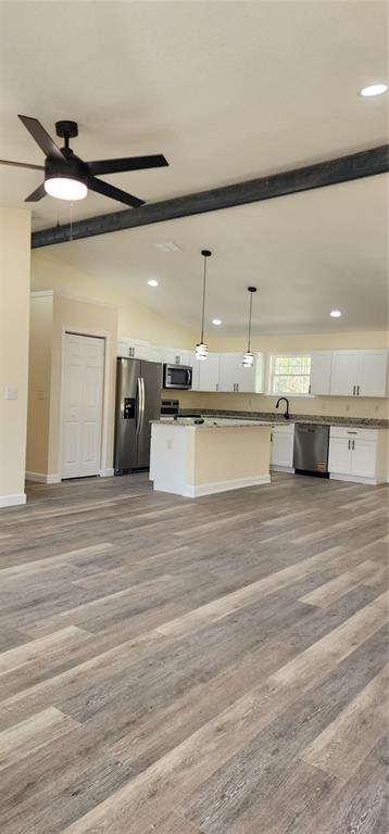 A kitchen with white cabinets, stainless steel appliances, and a central island with pendant lights — 2988 SW BONABLE DRIVE, DUNNELLON, FL