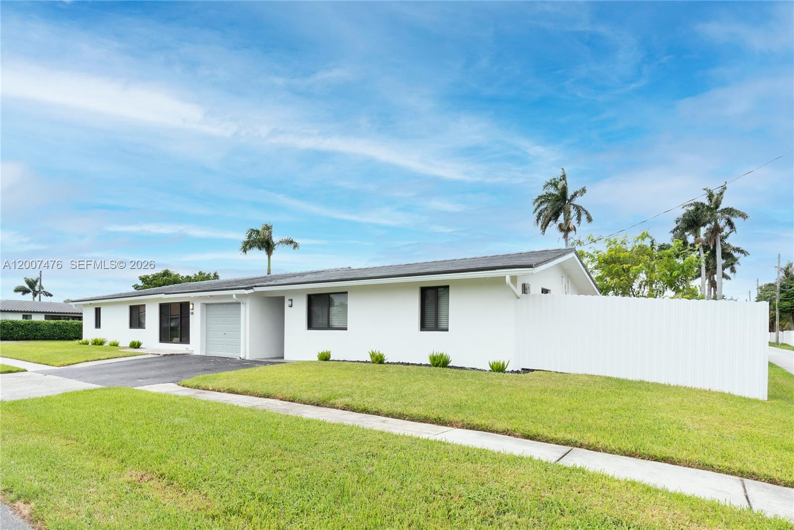 A white single-story house with a garage and a white vinyl privacy fence — 510 SE 3rd Ave # A, Dania Beach FL 33004, DANIA BEACH, FL