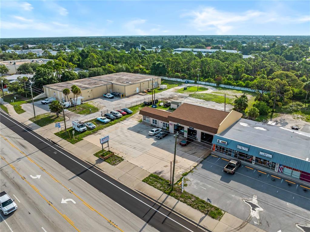 An aerial view shows a commercial property with two buildings, a parking lot, and a road — 101 S INDIANA AVENUE, ENGLEWOOD, FL