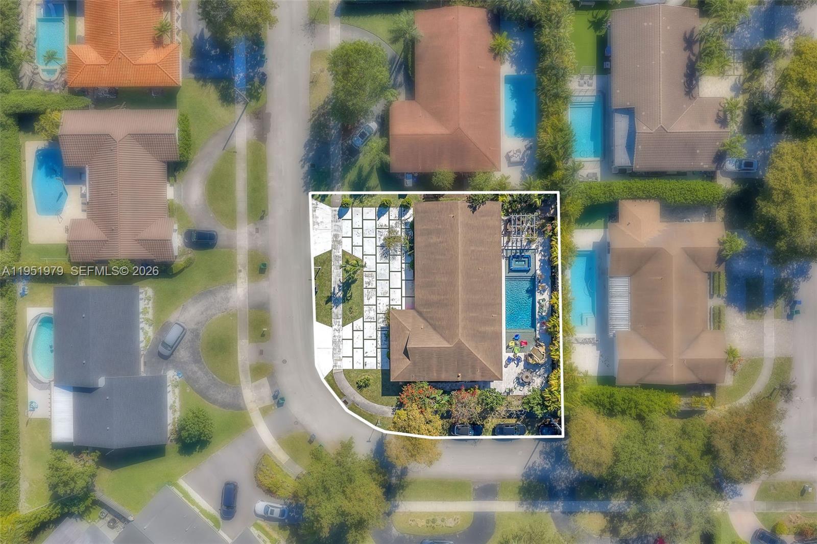 This aerial view shows a residential property with a pool, patio, and paved driveway — 21424 NE 19th Ct, Miami FL 33179, MIAMI, FL