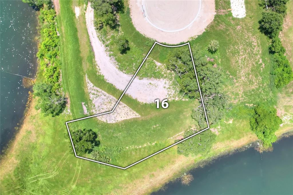 An aerial view shows a vacant, irregularly shaped residential lot marked with the number 16 — 133 TRANQUIL MIRROR LAKE COURT Lot 16, CLERMONT, FL