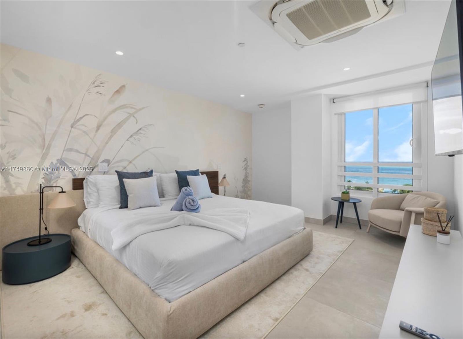 A bedroom features a king bed, a mural wall, and a window overlooking the ocean — 1 NW IRAUSQUIN BLV # 1A, Au, Au