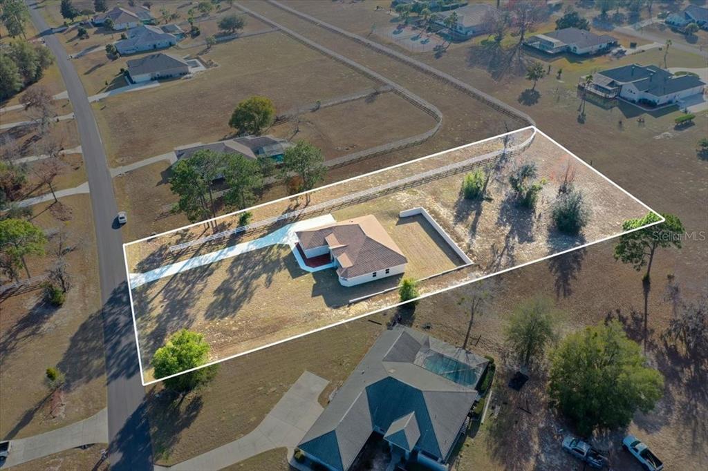 An aerial view shows a single-story house situated on a fenced, rectangular residential lot — 1464 N HAMBLETONIAN DRIVE, HERNANDO, FL