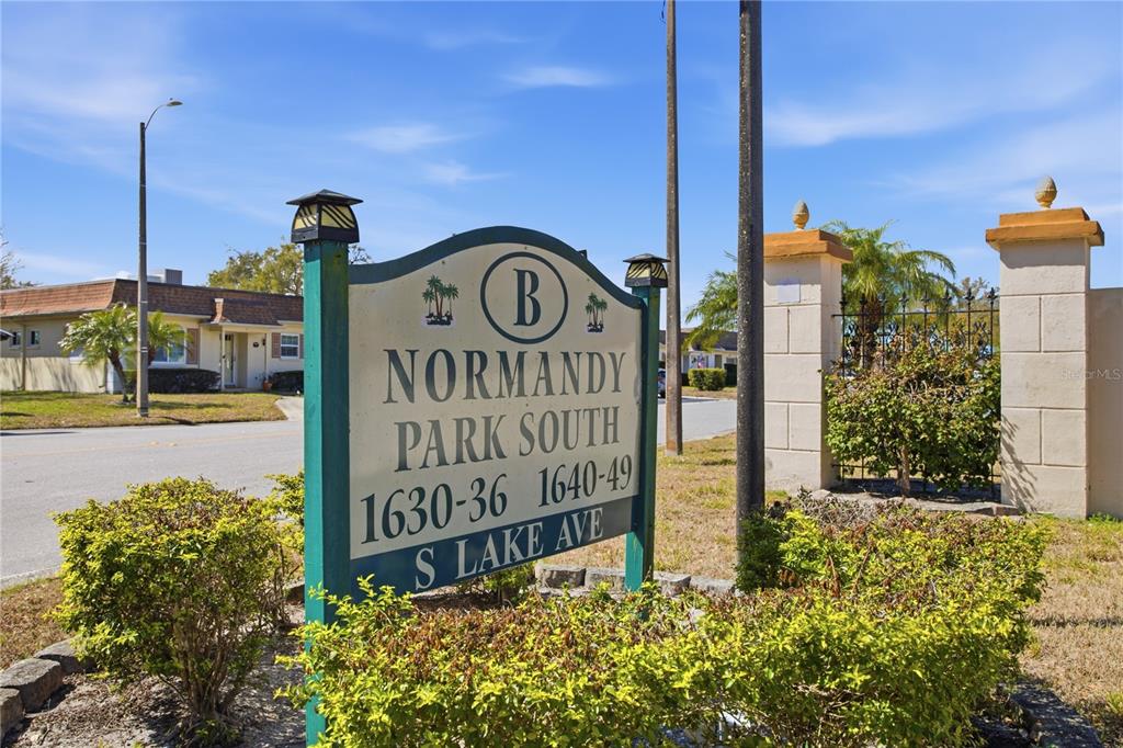 A sign for Normandy Park South stands in front of a gated residential entrance — 1636 S LAKE AVENUE UNIT 1, CLEARWATER, FL