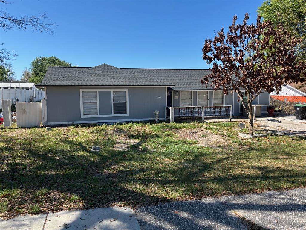 A single-story gray house with a dark shingled roof and a front porch — 5214 GAYMAR DRIVE, ORLANDO, FL