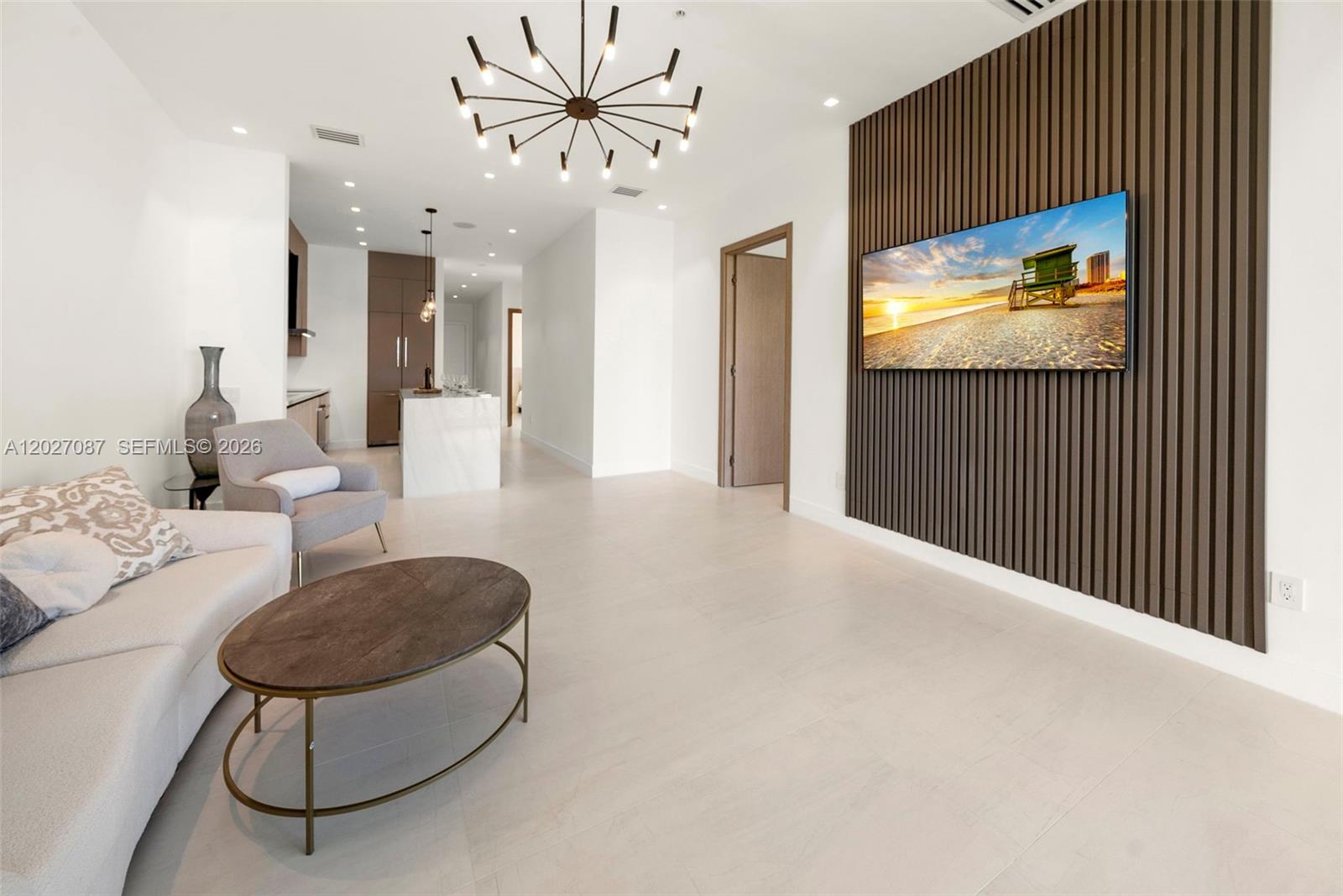 A modern living room features a slatted wood accent wall with a mounted television — 246 NE 6th Ave # 302, Delray Beach FL 33483, DELRAY BEACH, FL