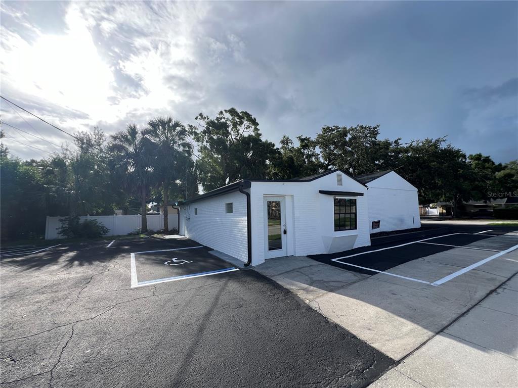 A white painted brick building with a handicap parking space in a paved lot — 512 S DALE MABRY HIGHWAY, TAMPA, FL