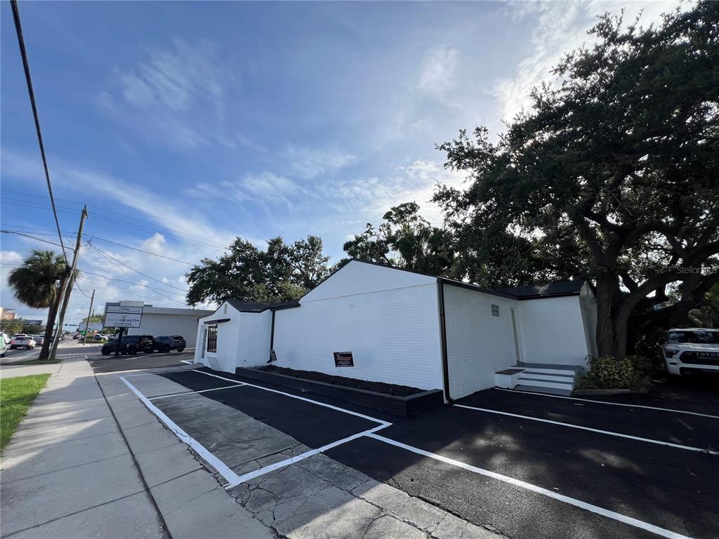 A white, single-story commercial building features a paved parking lot in front — 512 S DALE MABRY HIGHWAY, TAMPA, FL