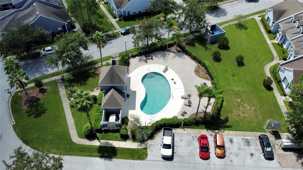 An exterior view of a multi-unit townhouse with blue doors, shutters, and multiple dormer windows — 2074 ISLAND WALK DRIVE, ORLANDO, FL