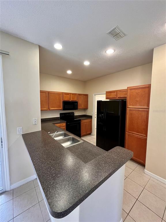 An aerial view shows a residential community with townhomes, a swimming pool, and a highway — 2074 ISLAND WALK DRIVE, ORLANDO, FL