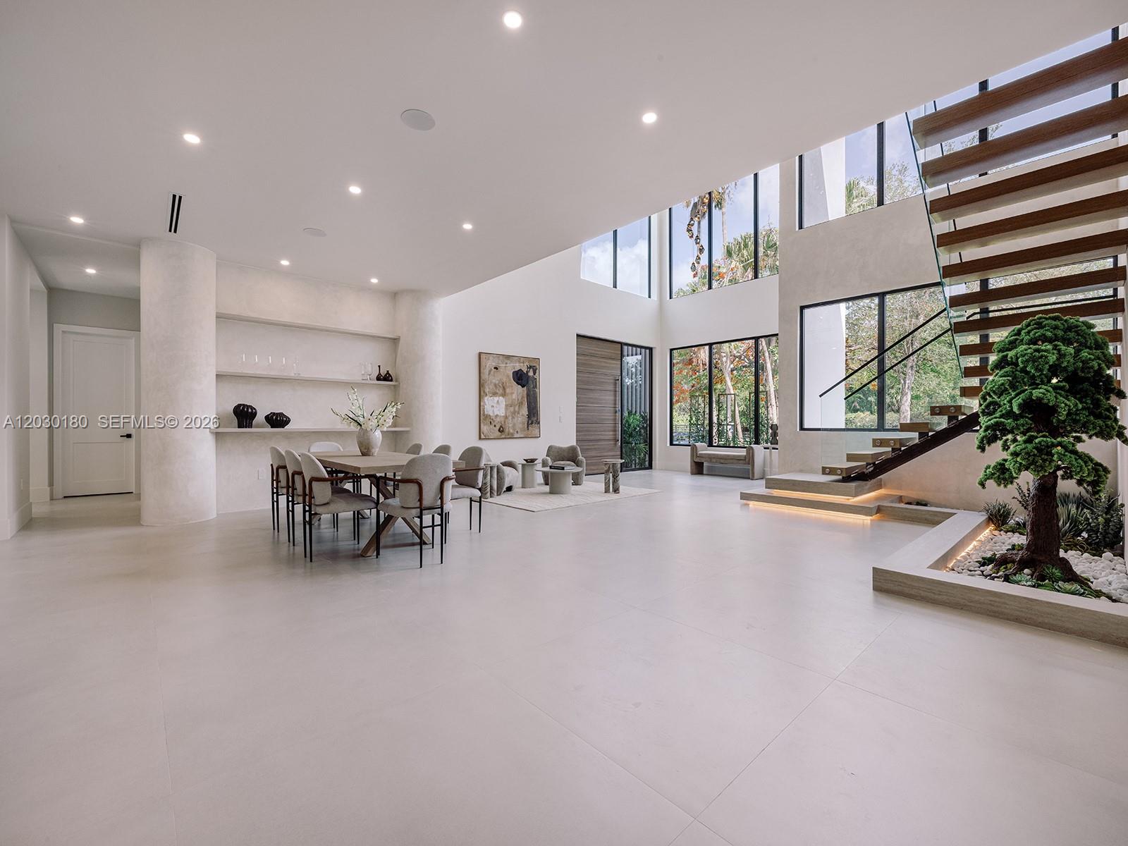 A modern two-story house features a circular concrete driveway with a central stone inlay — 9530 SW 95th Ct, Miami FL 33176, MIAMI, FL