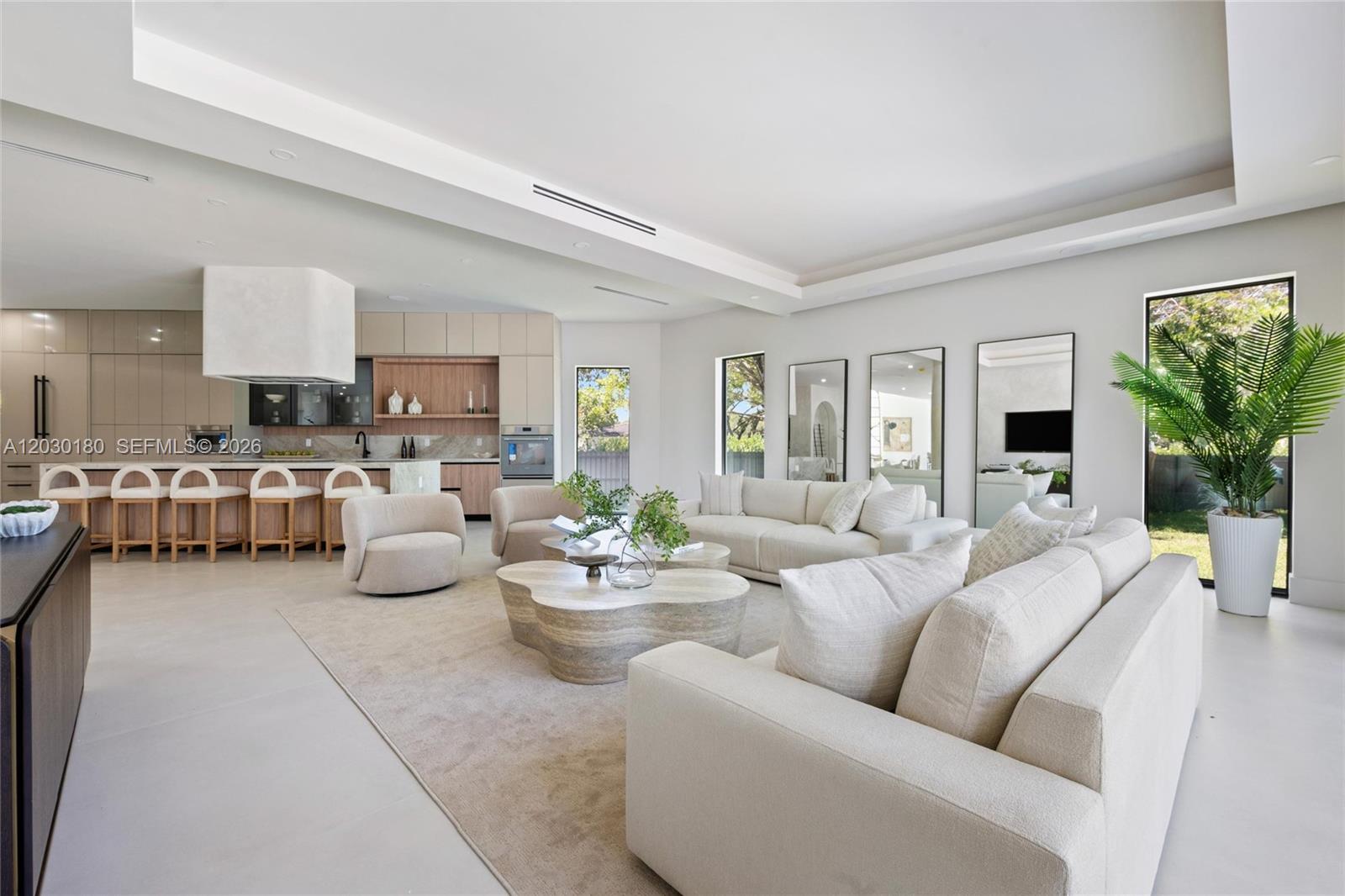 A spacious, modern open-concept living and dining area features a floating staircase and high ceilings — 9530 SW 95th Ct, Miami FL 33176, MIAMI, FL