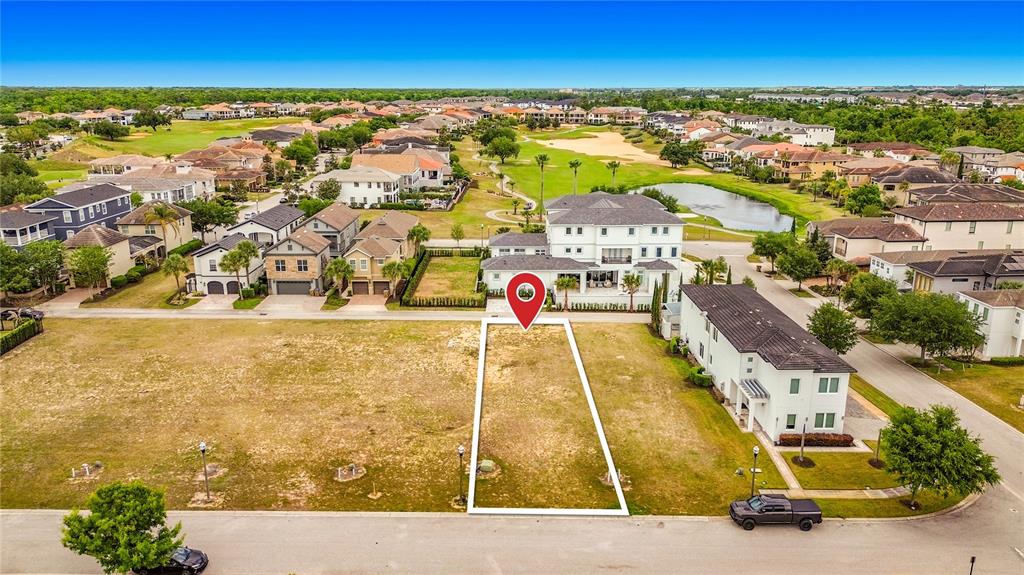 An aerial view shows a vacant residential lot outlined in white next to a house — 7805 LOXAHATCHEE COURT, REUNION, FL