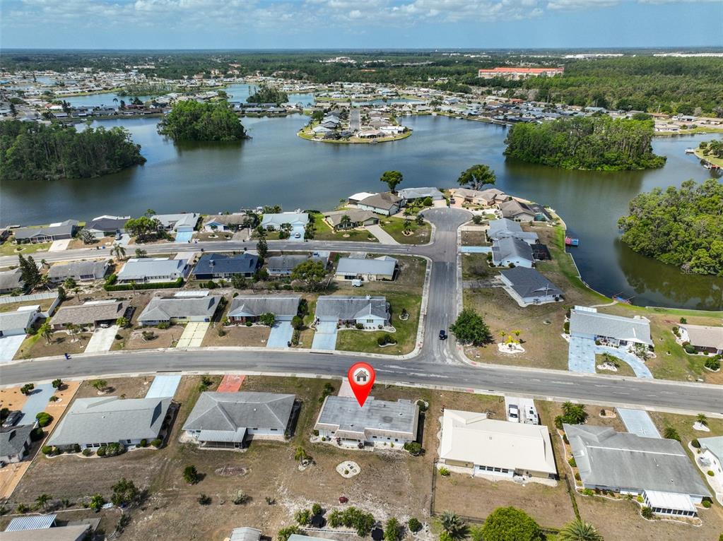 An aerial view shows a residential neighborhood with a house marked by a red pin — 1529 ALLEGHENY DRIVE, SUN CITY CENTER, FL
