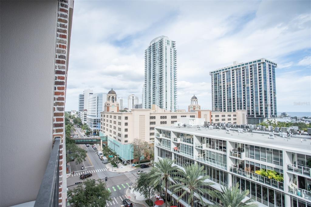 An elevated view of a city streetscape featuring modern high-rise buildings and palm trees — 175 2ND STREET S UNIT 808, ST PETERSBURG, FL