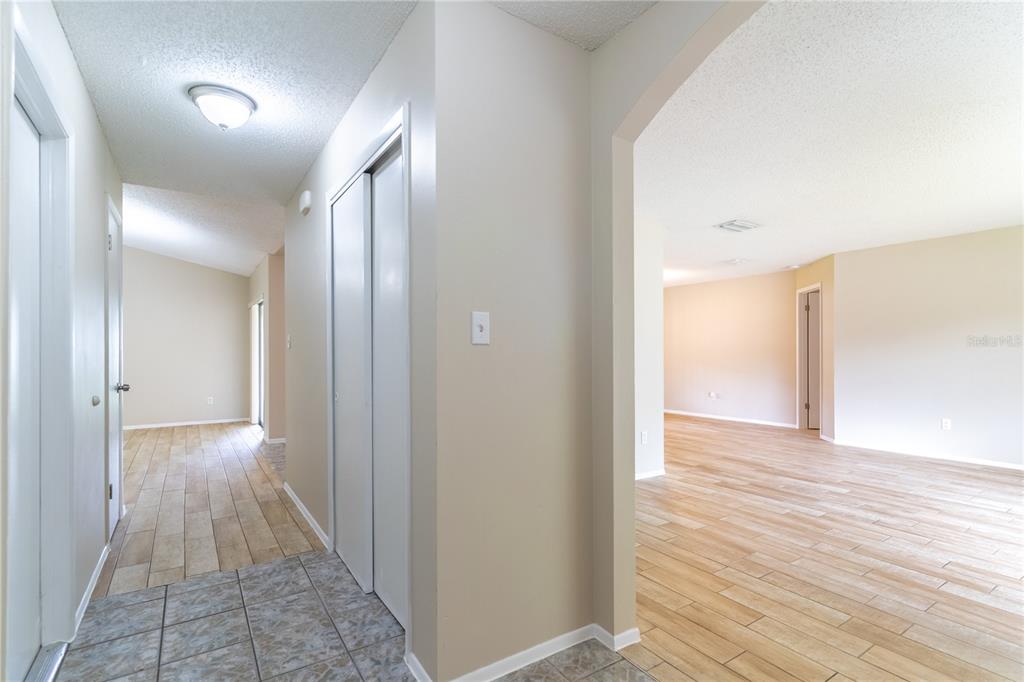 An interior view shows a tiled entryway leading to a hallway and a living area — 9624 TETLEY COURT, ORLANDO, FL