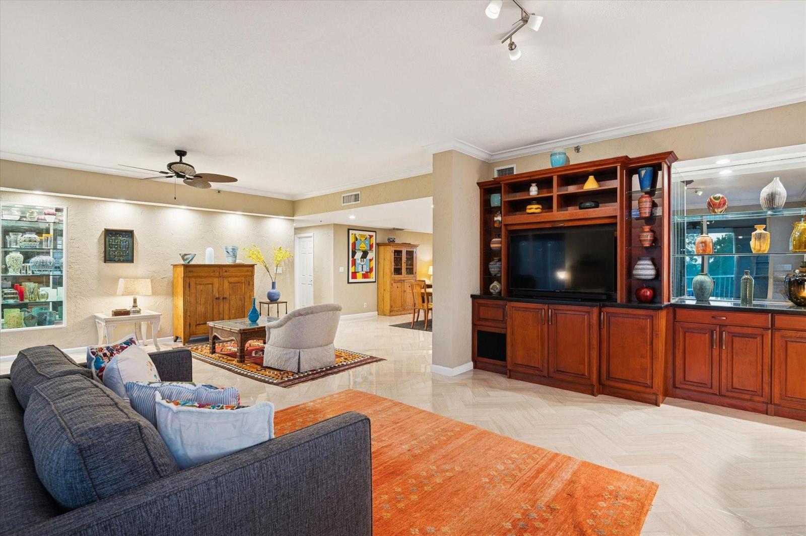A living room features a large wooden entertainment center, a grey sofa, and tile flooring — 4112 W Palm Aire Drive # 124a, Pompano Beach FL 33069, POMPANO BEACH, FL