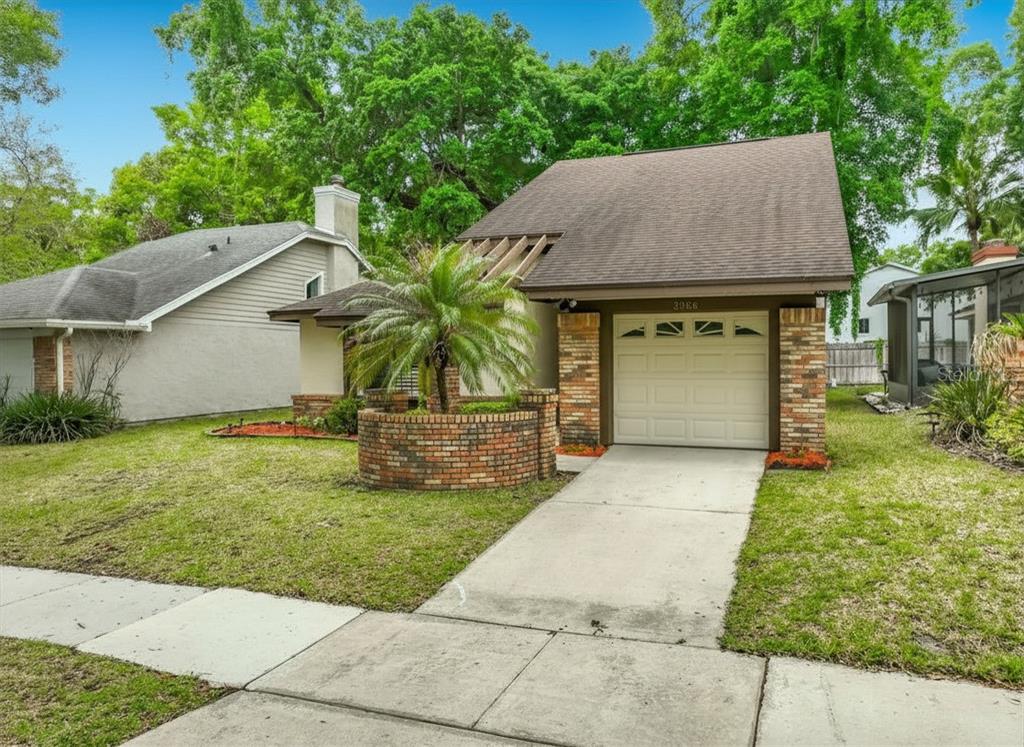A single-story house with a brick facade, a palm tree, and a concrete driveway — 2966 GOLDEN VIEW LANE, ORLANDO, FL