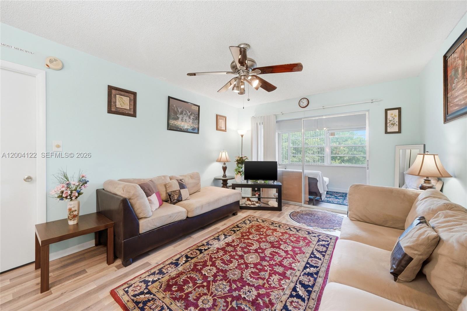 A living room features light blue walls, two beige sofas, and a large patterned rug — 3190 Holiday Springs Blvd # 306, Margate FL 33063, MARGATE, FL