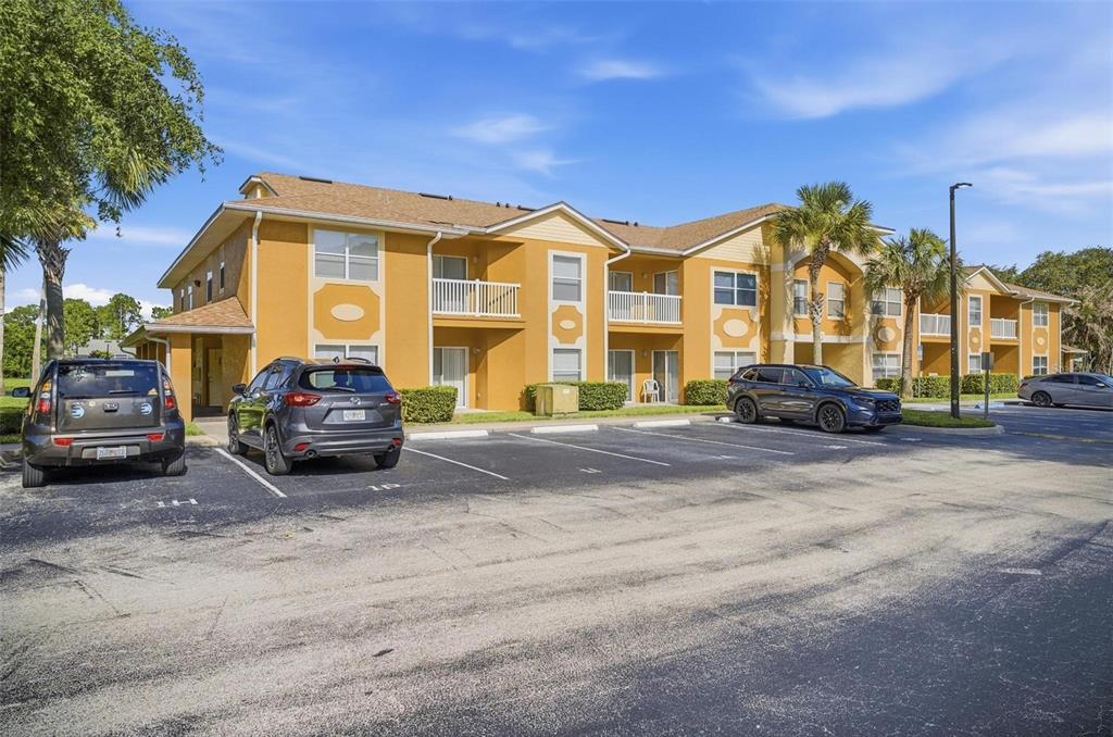 A two-story apartment building with yellow stucco walls and a parking lot in front — 4600 E MOODY BOULEVARD UNIT 1P, BUNNELL, FL