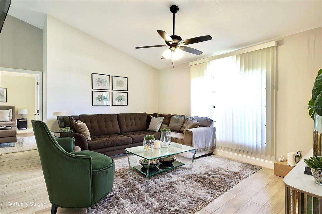 A living room features a brown sectional sofa, a green armchair, and a glass coffee table — 719 PINE TERRACE COURT, ALTAMONTE SPRINGS, FL