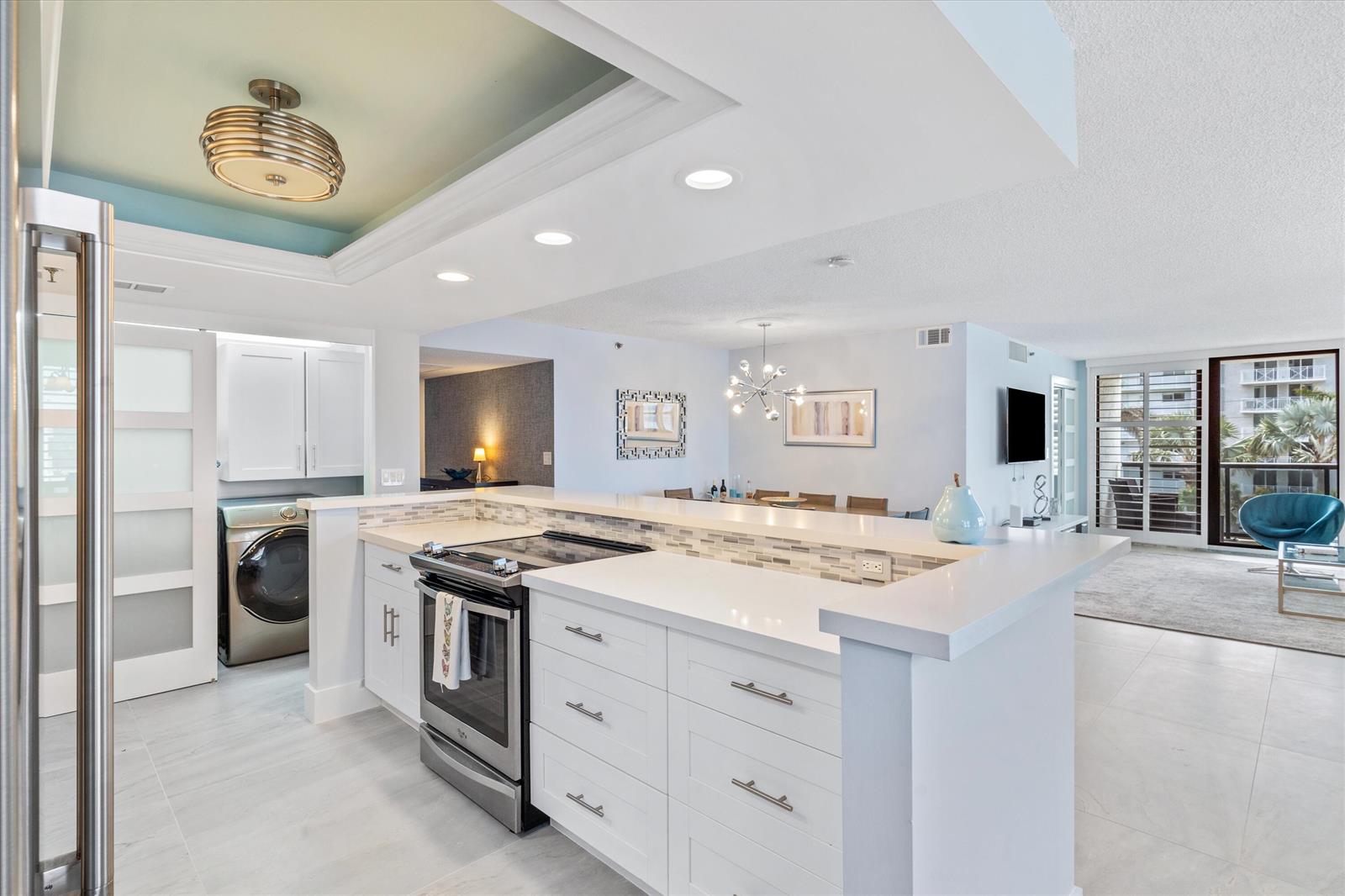 A modern kitchen with white cabinets, quartz countertops, and a stainless steel stove — 3115 S Ocean Boulevard # 302, Highland Beach FL 33487, HIGHLAND BEACH, FL