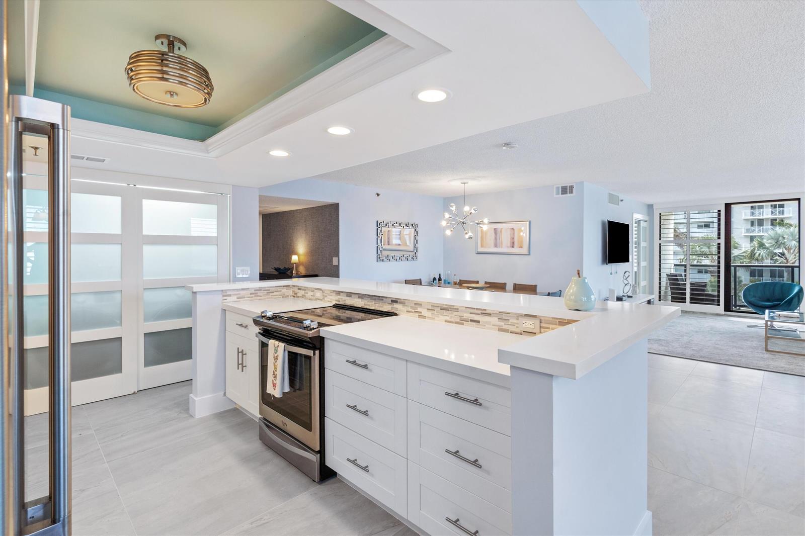 A modern kitchen with white cabinets, quartz countertops, and a stainless steel oven — 3115 S Ocean Boulevard # 302, Highland Beach FL 33487, HIGHLAND BEACH, FL