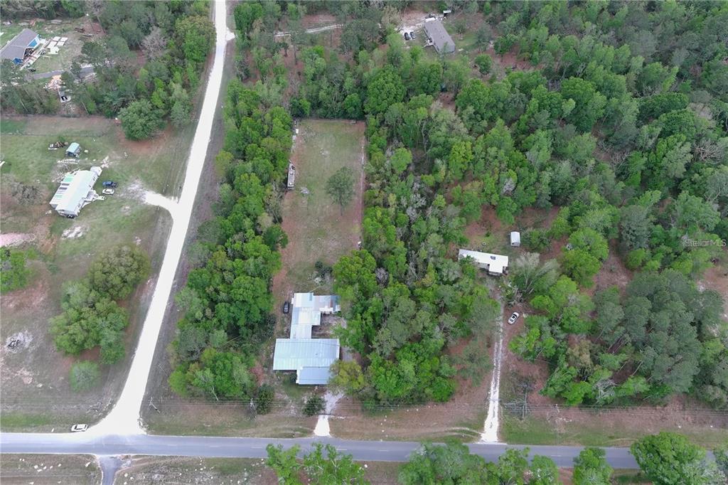 An aerial view shows a house on a wooded lot with a long driveway — 0 144TH STREET, LIVE OAK, FL