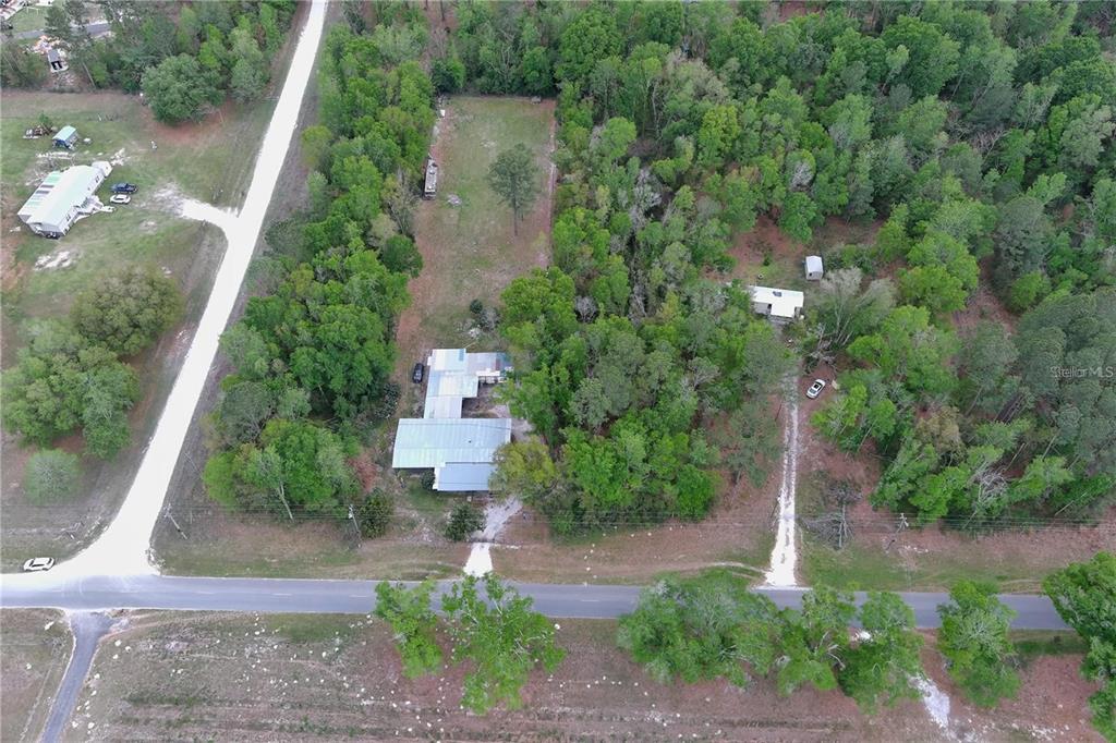 An aerial view shows two houses on wooded lots along a rural road — 0 144TH STREET, LIVE OAK, FL