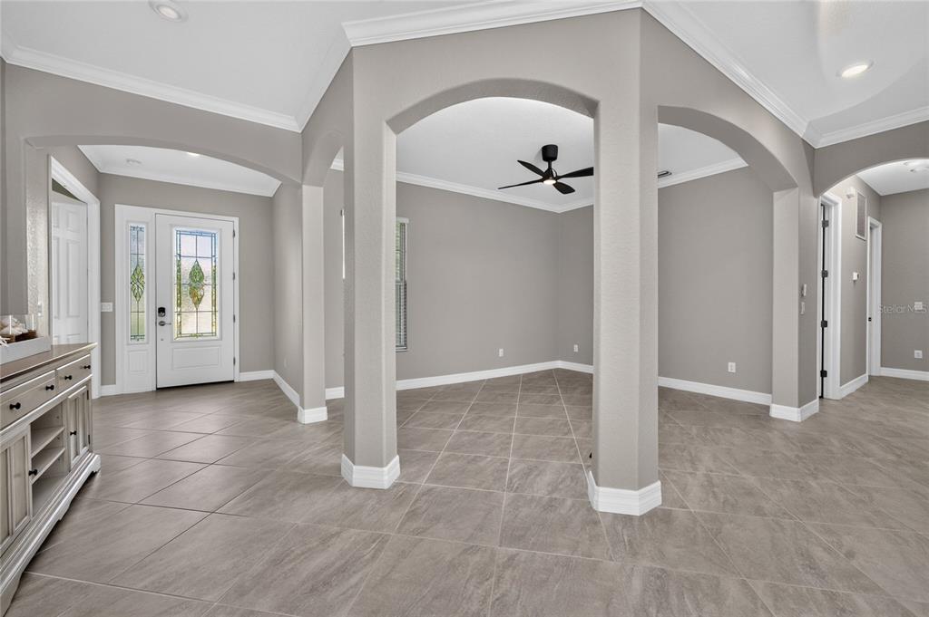 An entryway leads into a dining area defined by arched architectural columns and tile flooring — 15248 SPANISH POINT DRIVE, PORT CHARLOTTE, FL